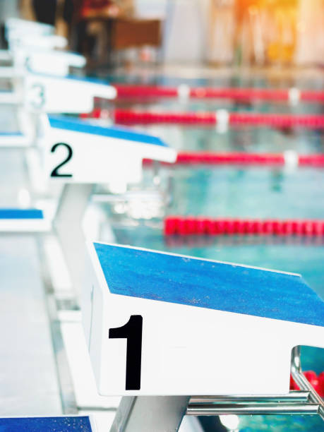 Starting table with numbers for diving in Olympic pool. Swimming pool for competitions with lane demarcation. Background.