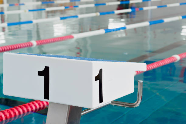istock Starting table with numbers for diving in Olympic pool. Swimming pool for competitions with lane demarcation. Background. 1441696401