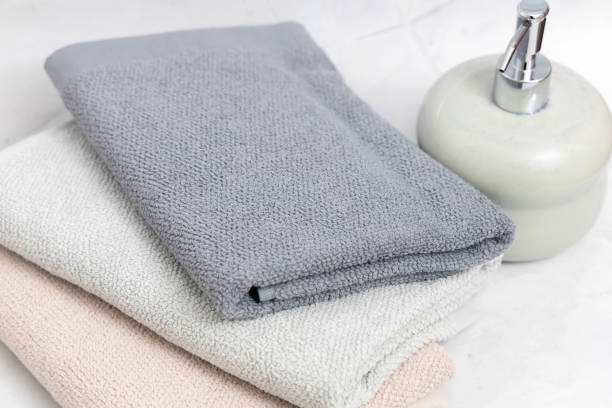istock Ceramic soap dispenser and folded towel. 1441696951