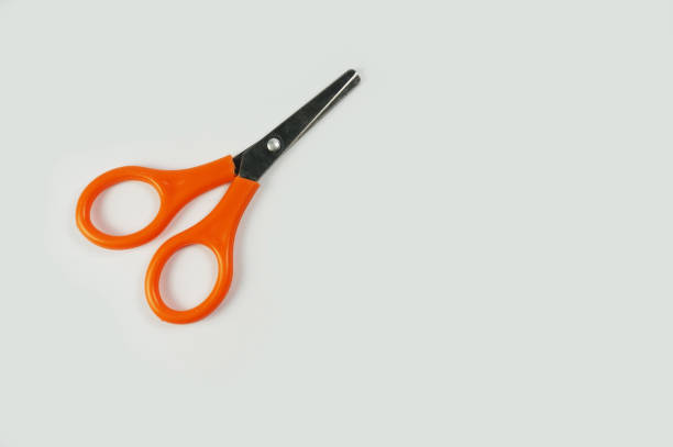 istock orange color scissors isolated on white background. 1441697818