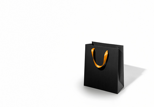 Black gift bag on white background with copy space.