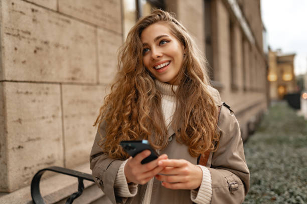 istock Young woman using mobile device standing in the city 1441699754