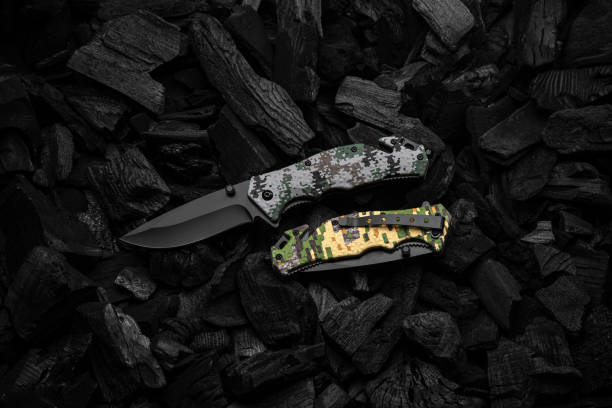 istock Modern penknife with black blade and camouflage handle. Dark charcoal background. 1441700932