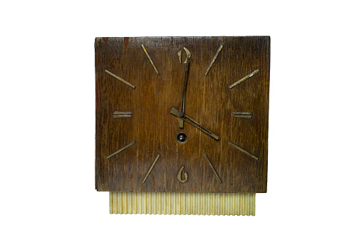 An old tool for measuring time. Household clock with rusty hands.