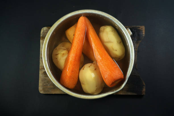 Carrots and potatoes on water. isolated on black or dark background Carrots and potatoes on water. isolated on black or dark background karman stock pictures, royalty-free photos & images