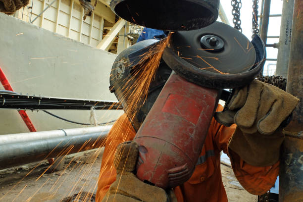 istock Worker grinding the iron pipe at coal fired power plant project. 1441709339