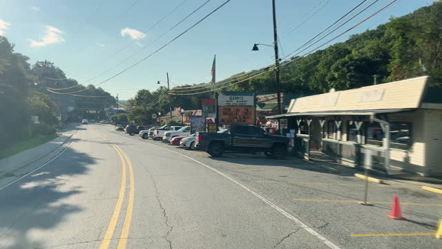 Car Point of View Shot of Driving through the Village of Chimney Rock, North Carolina While Passing a Few Businesses in on a Bright, Sunny Morning
