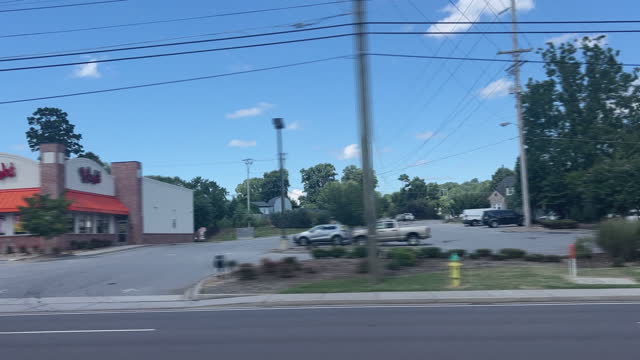 Side Car View of Driving by Businesses in Knoxville, Tennessee on a Sunny Day