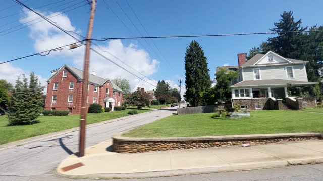 Side Car Point of View Shot of Driving Past Houses in Canton, North Carolina on a Sunny Day