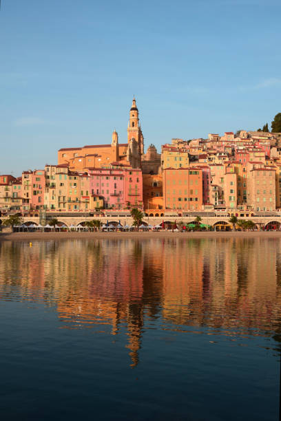 Old City of Menton, France at Dawn Reflected in the Water stock photo