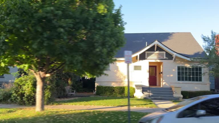 Side View of Driving through a Tree-Lined Neighborhood of Large Houses in Boise, Idaho at Sunset