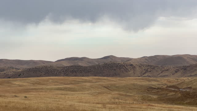 Side Car Point of View of Mountains and Plains Northwest of Boise, Idaho under a Stormy, Dramatic Sky