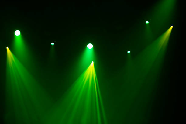 istock Green stage light from spotlights on a dark background. 1441711240