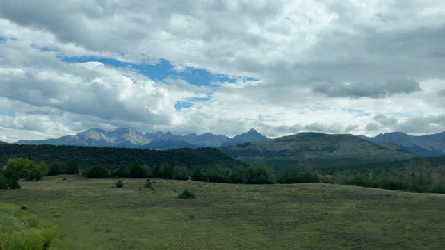 Side Car Point of View Shot of Driving Past Wilderness in the San Juan Mountains in Western Colorado under a Cloudy Sky