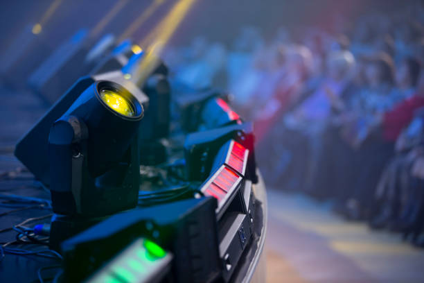 istock Light from stage lights against the background of blurry spectators. 1441711345