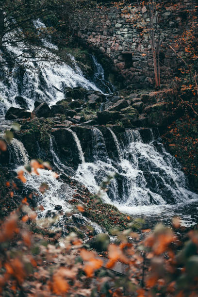 istock Beautiful waterfall in autumn forest in Jonkoping, Sweden. 1441711578