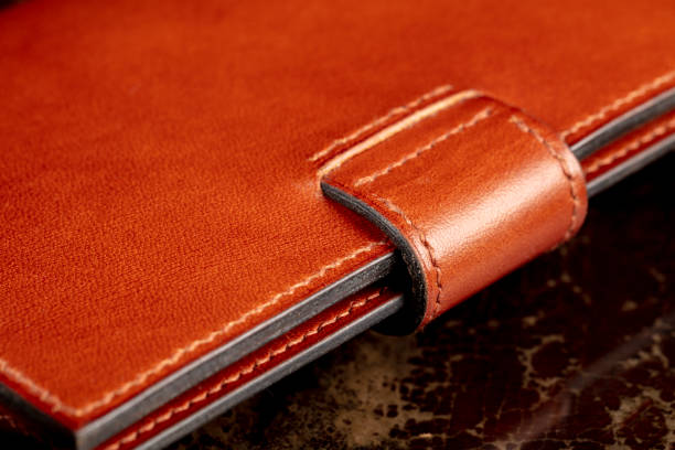istock Part of a brown leather wallet or case with stitching. 1441711653