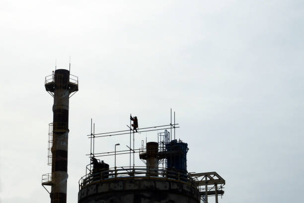 Scaffolder installing scaffolding on top of the building Sangatta, Kutai Timur, East Borneo, Indonesia. 06/07/2017. Coal Fired Power Plant Project. Scaffolder installing scaffolding on top of the building karman stock pictures, royalty-free photos & images