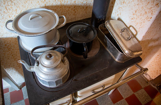 Gas stove and dirty frying pan in the kitchen in an apartment in Ukraine, kitchen furniture and appliances, kitchen interior