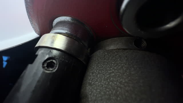Macro Shot of a Turret Press Expanding the Neck of a Brass .38 Special Case while Ammunition Reloading in a Domestic Garage