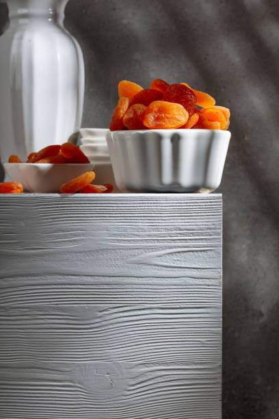 Dried apricots on a white wooden table.