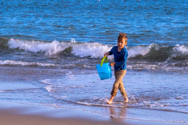 Boy playing on the seashore on the beach.