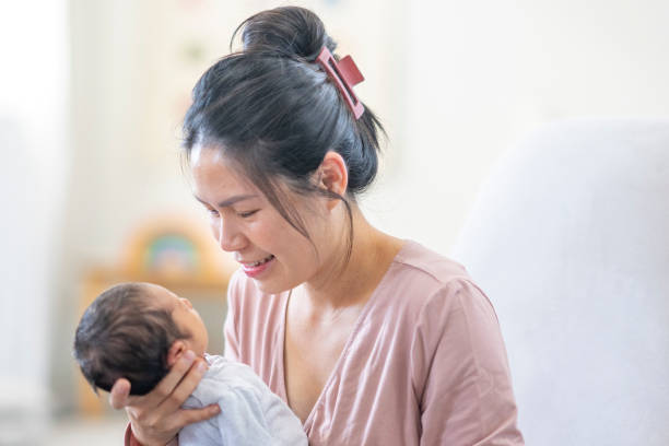 istock Sleeping Newborn in Mothers Hands 1441721816