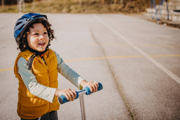istock Little boy riding a push scooter 1441725987