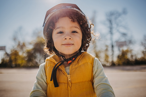 Close-up portrait of little boy wearing  helmet