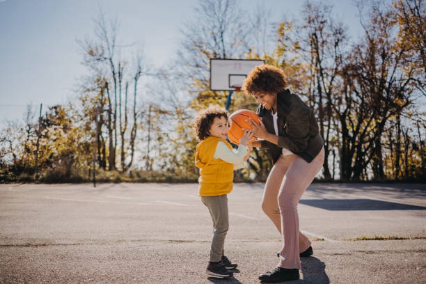 istock Mother playing basketball with her son 1441726650