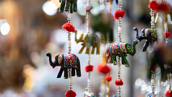 Christmas decorations of tiny elephants, stone miniatures with elephant scent, blurred background, image with space for text