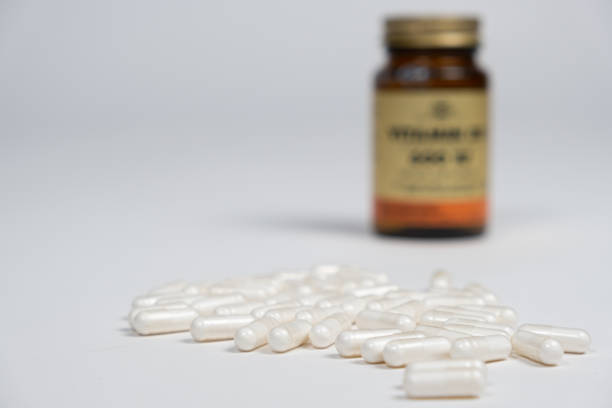 istock White capsules of medicines or vitamins on a white background, space for text 1441728090