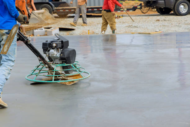 The process of polishing and leveling cement screed mortar floors on the construction site in the process of construction stock photo
