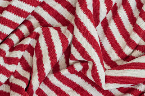 istock Textile texture, abstract background. Red - white striped color, smooth wavy lines 1441730121