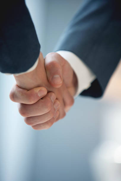 Business persons shaking hands stock photo