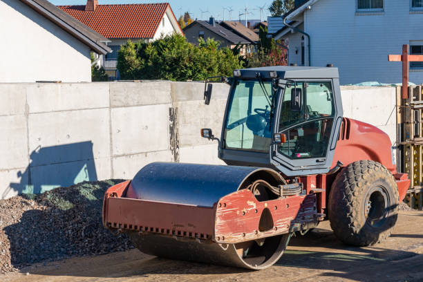 istock Road roller standing on a construction site near a concrete fence. 1441735029