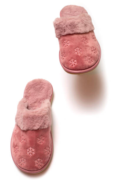 istock Pink warm women's slippers on a white background 1441736365