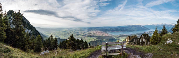Viewpoint with park bench in bernese Oberland with view to the city of Thun and the lake Thun, Switzerland stock photo