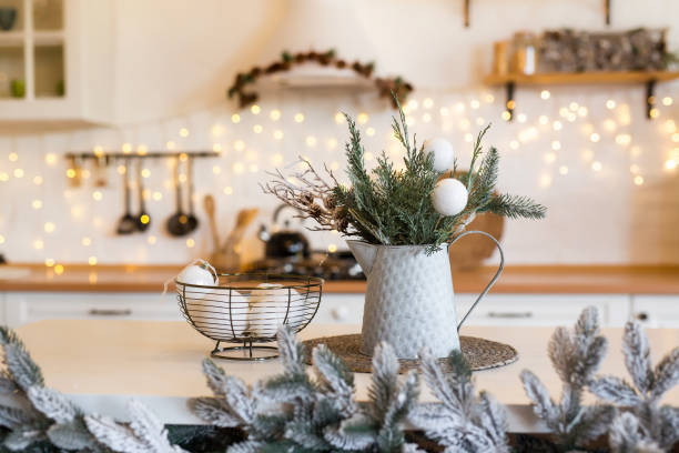 istock Christmas composition. White balls and fir tree branches on decorated kitchen background. Christmas, winter, new year concept. 1441736762