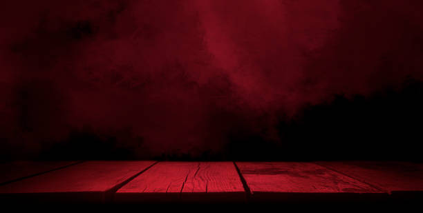 istock Wooden table on black wall 1441736826