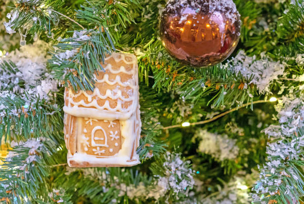 istock Gingerbread house with icing on a Christmas tree. 1441738107