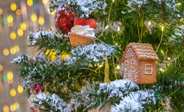 istock Gingerbread house with icing on a Christmas tree. 1441738125