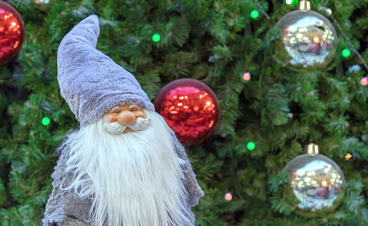Christmas gnome with a white beard in a large fur hat.