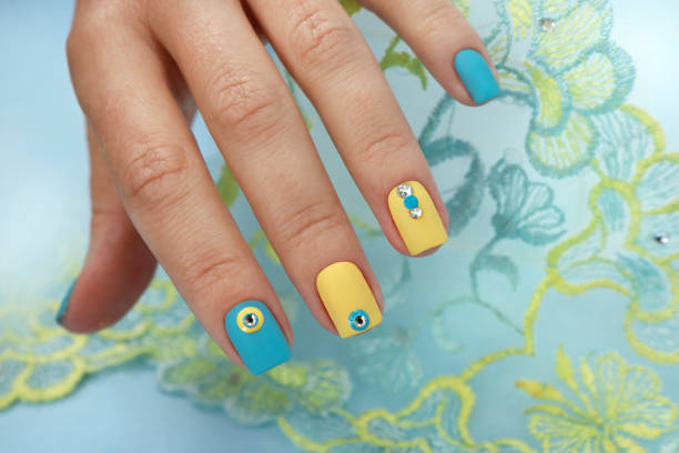 istock Yellow blue manicure on short nails. 1441739248