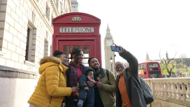 Multi-generation Black family taking selfie in London