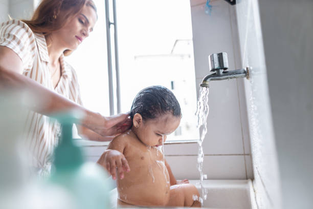 istock Young mother bathing her baby daughter 1441745637