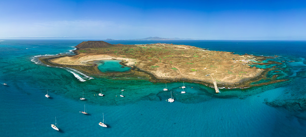 High level panoramic image of Lobos island and sheltered bay looking very tropical in the sunshine, near Corralejo Fuerteventura