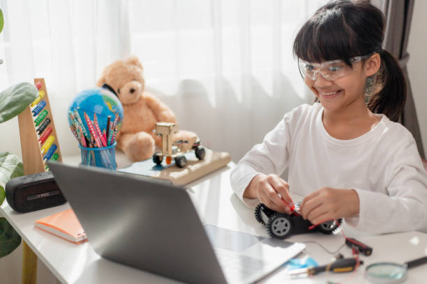 istock Asia students learn at home in coding robot cars and electronic board cables in STEM, STEAM, mathematics engineering science technology computer code in robotics for kids concept. 1441745692