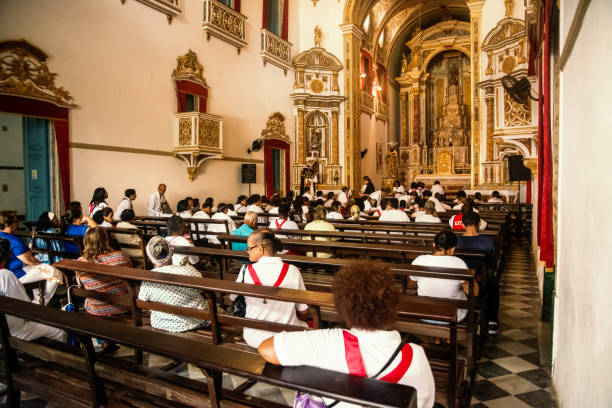 catholics are inside the church praying on the day of homage to corpus christ - confessional nun imagens e fotografias de stock