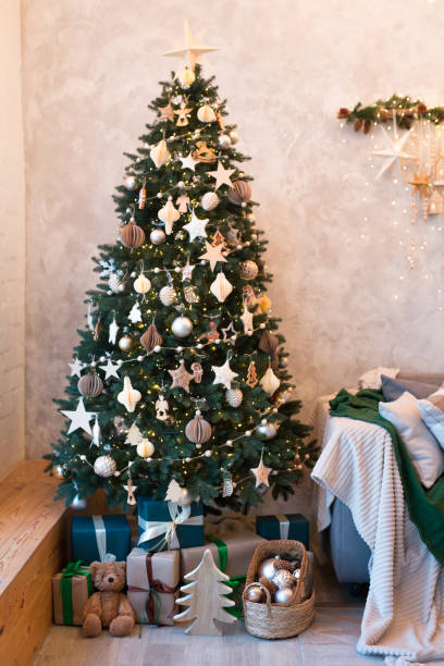 istock Christmas tree and gifts in home interior 1441748759
